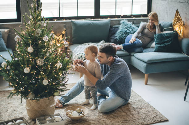 Father and daughter decorate a christmas tree | Allied Flooring & Paint