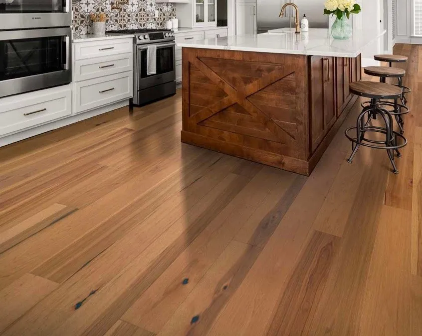 Modern kitchen featuring warm hardwood flooring, a dark wood island, and barstools.Modern kitchen featuring warm hardwood flooring, a dark wood island, and barstools.